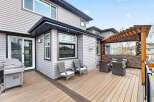 Enjoy outdoor living at its finest with this stunning property featuring a spacious deck and a cozy pergola.