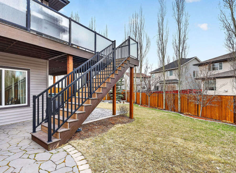 Enjoy outdoor living with this stunning property featuring a spacious deck and a beautifully landscaped backyard.