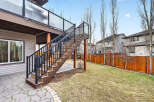 Enjoy outdoor living with this stunning property featuring a spacious deck and a beautifully landscaped backyard.