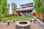 Enjoy outdoor living at its finest in this stunning backyard oasis! Featuring a spacious deck, a cozy fire pit area, and lush green lawn, this property is perfect for entertaining or relaxing.