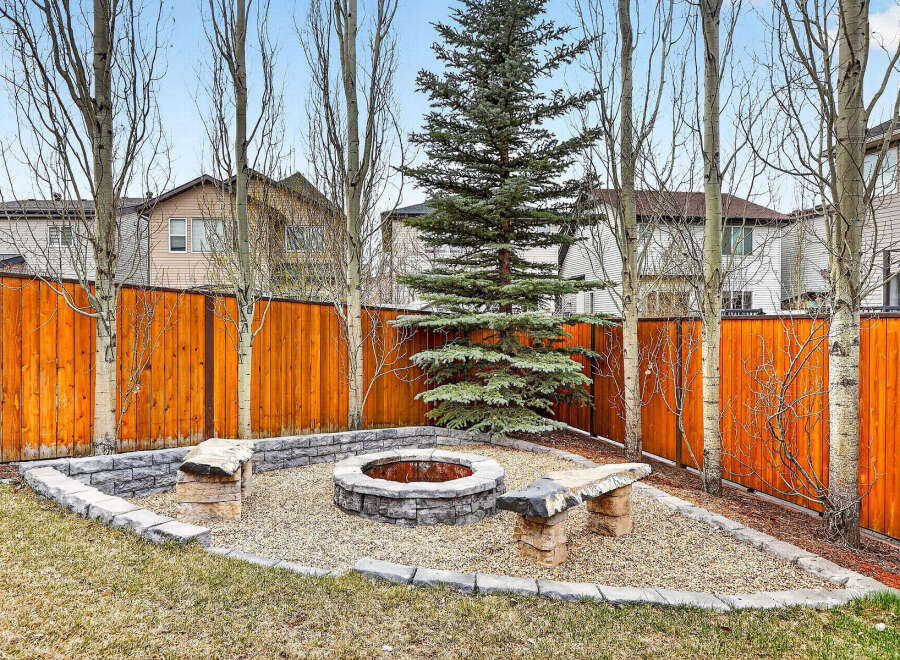 Enjoy outdoor living in this stunning backyard oasis! Featuring a cozy fire pit area, perfect for entertaining or relaxing.