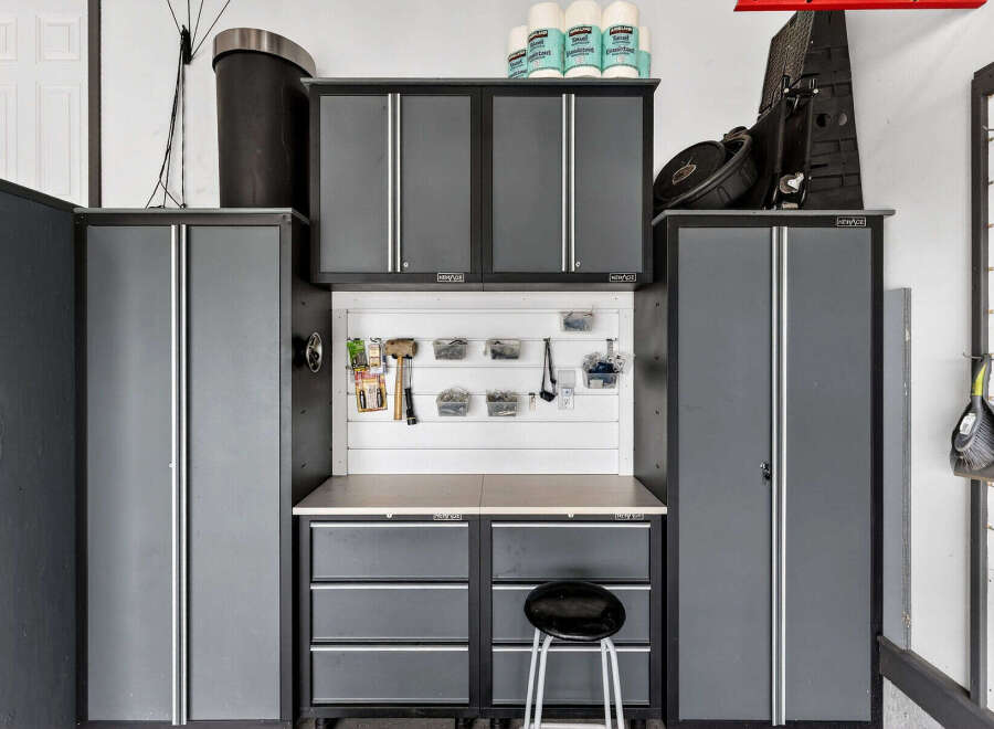 This well-organized garage space features ample storage solutions, including cabinets and drawers, perfect for keeping tools and equipment neatly arranged.
