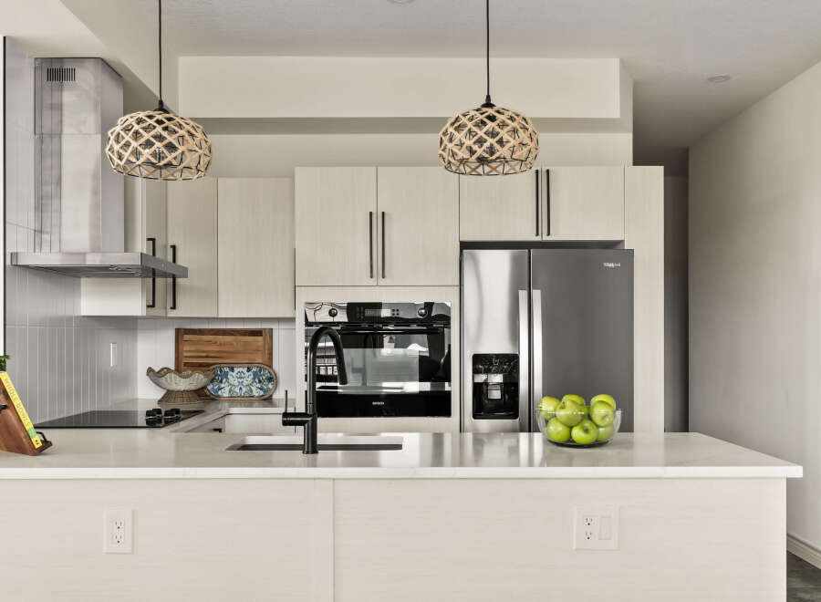 This modern kitchen boasts sleek design and high-end appliances, perfect for culinary enthusiasts.