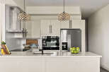 This modern kitchen boasts sleek design and high-end appliances, perfect for culinary enthusiasts.