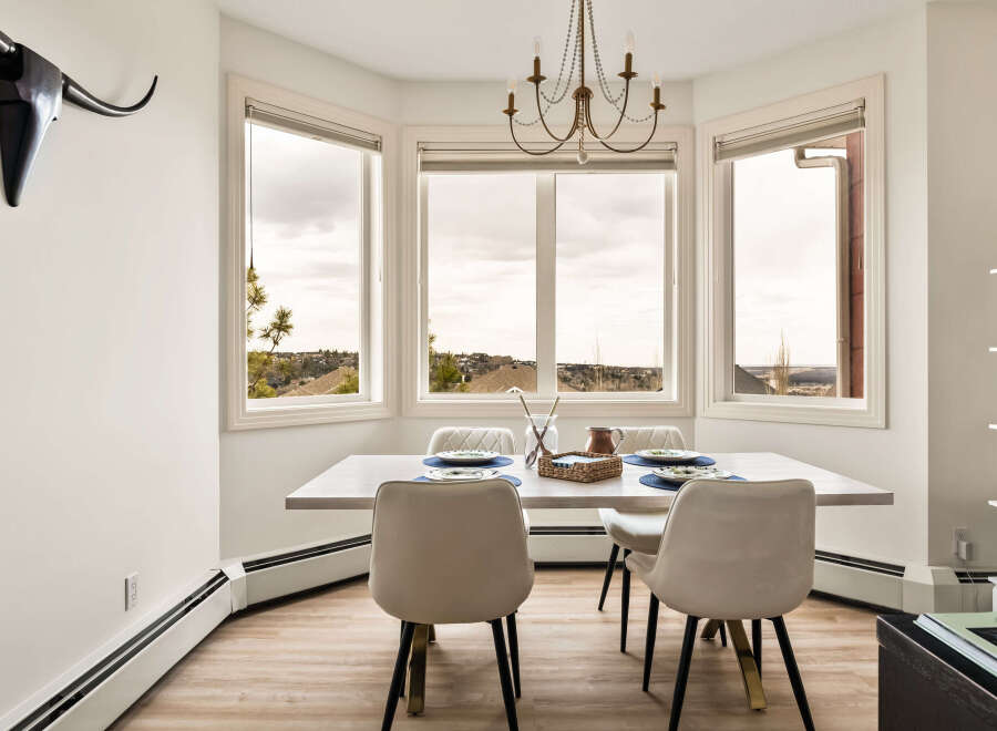 This stunning dining room boasts a bright and airy atmosphere, perfect for hosting gatherings.