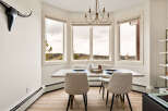 This stunning dining room boasts a bright and airy atmosphere, perfect for hosting gatherings.