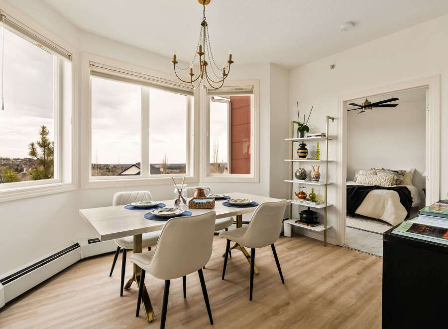 This stunning dining room boasts an abundance of natural light, thanks to the large windows that offer breathtaking views.