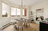 This stunning dining room boasts an abundance of natural light, thanks to the large windows that offer breathtaking views.