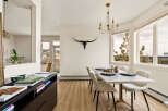 This stunning dining room boasts a modern aesthetic with a touch of rustic charm.
