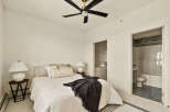 Step into this inviting bedroom, featuring a cozy bed adorned with stylish pillows and a soft throw.