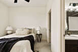 Step into this inviting bedroom, featuring a cozy bed adorned with stylish pillows and a plush throw.
