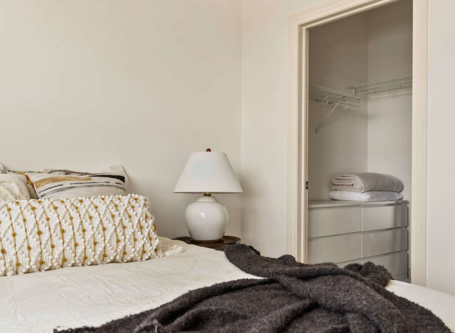 This cozy bedroom features a comfortable bed with stylish pillows and a soft blanket, perfect for relaxation.