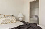 This cozy bedroom features a comfortable bed with stylish pillows and a soft blanket, perfect for relaxation.