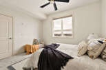 This cozy bedroom offers a serene retreat with its neutral color palette and ample natural light.