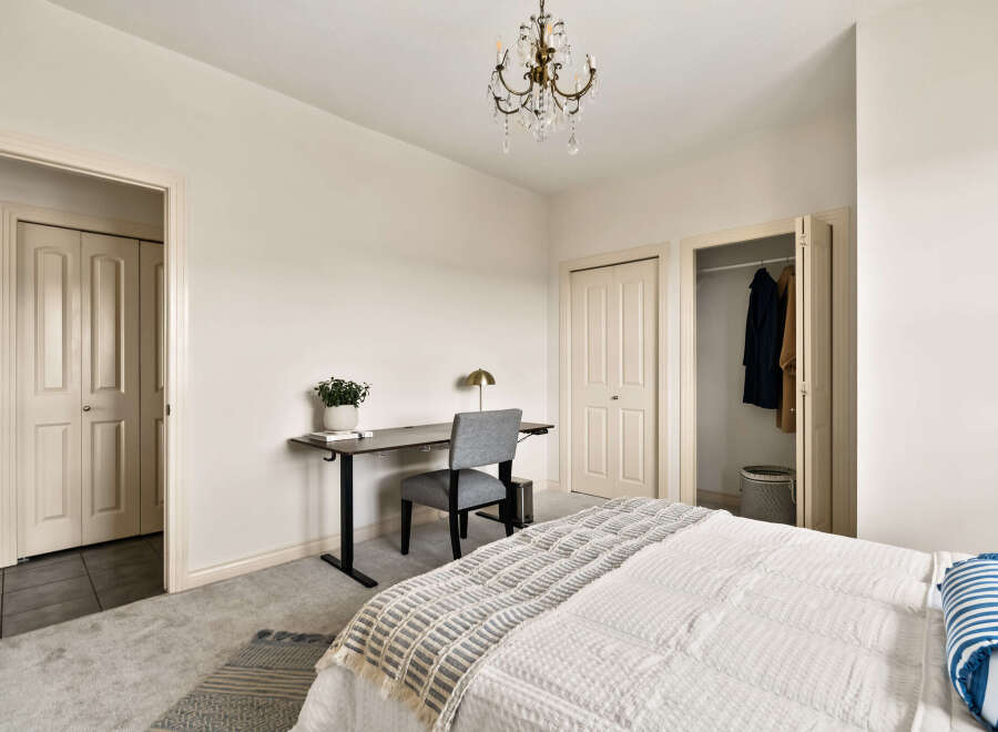 This inviting bedroom features a cozy workspace, perfect for remote work or studying.