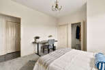 This inviting bedroom features a cozy workspace, perfect for remote work or studying.