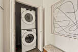 This stunning property boasts a modern laundry area, featuring a stacked Whirlpool washer and dryer for ultimate convenience.