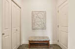 Step into this inviting entryway, showcasing a stylish bench and a captivating piece of art.
