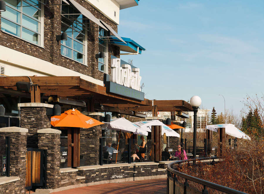 This stunning property boasts a prime location with a vibrant outdoor dining area, perfect for enjoying sunny days.