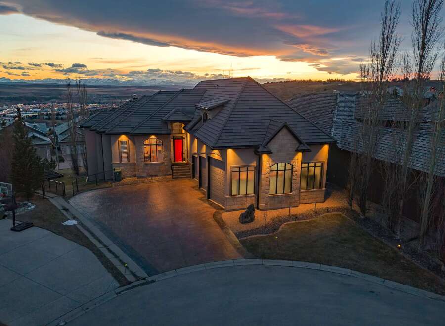 This stunning property showcases a luxurious home with a striking red front door, exuding curb appeal.