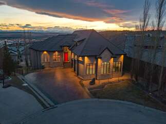 This stunning property showcases a luxurious home with a striking red front door, exuding curb appeal.
