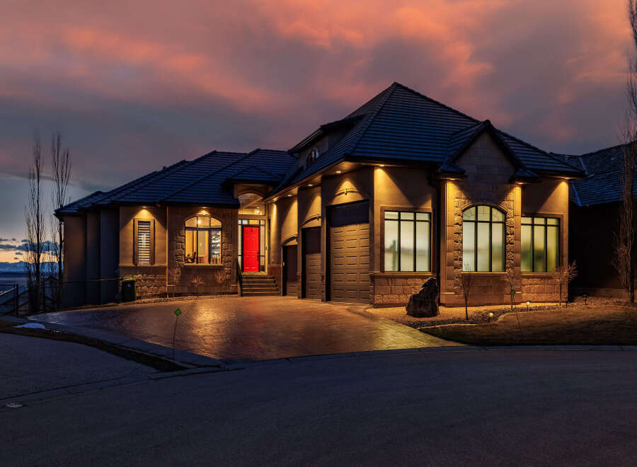 This stunning property showcases a beautiful home with a striking red front door, exuding curb appeal.