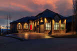 This stunning property showcases a beautiful home with a striking red front door, exuding curb appeal.