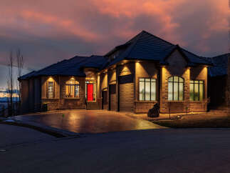 This stunning property showcases a beautiful home with a striking red front door, exuding curb appeal.