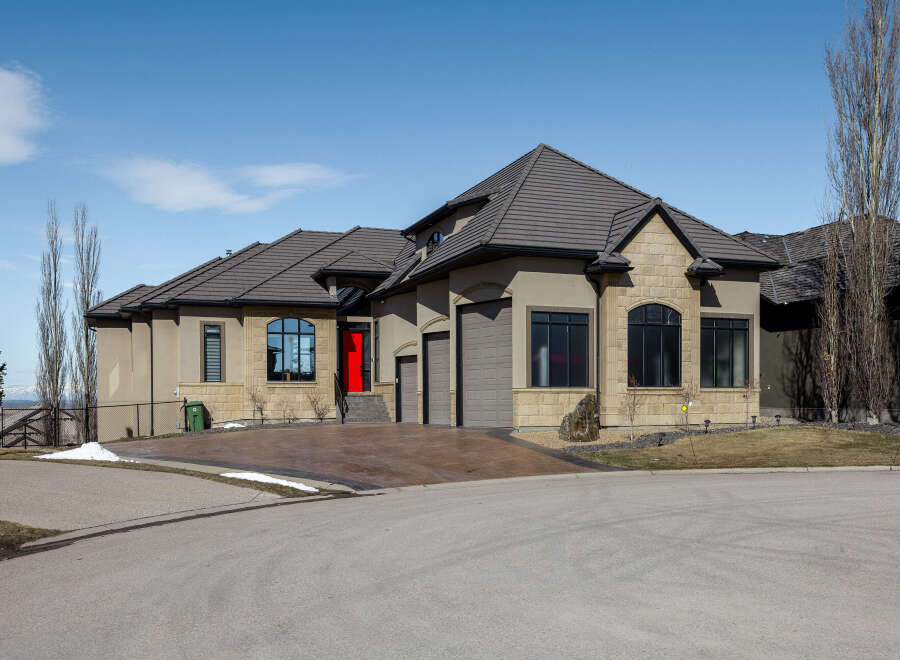 This stunning property boasts a modern design with a striking red front door, complemented by a neutral exterior.