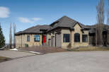 This stunning property boasts a modern design with a striking red front door, complemented by a neutral exterior.