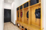 This entryway features a custom-built mudroom with ample storage, perfect for keeping your home organized.