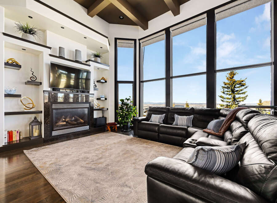 Experience luxury living in this stunning property featuring a cozy fireplace and a modern entertainment setup.