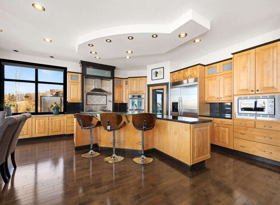 This stunning kitchen boasts a modern design with sleek cabinetry and a spacious layout, perfect for culinary enthusiasts.