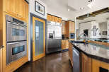 This stunning kitchen boasts modern appliances and elegant wooden cabinetry, perfect for culinary enthusiasts.