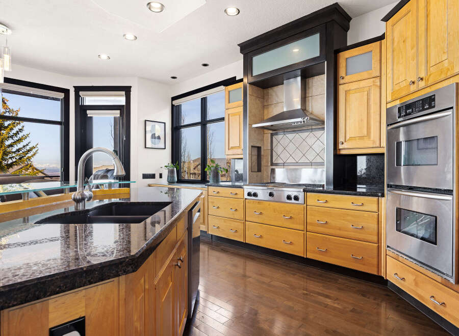 This stunning kitchen boasts a modern design with high-end appliances and ample storage.