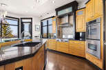 This stunning kitchen boasts a modern design with high-end appliances and ample storage.