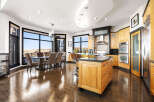 This stunning kitchen boasts a modern design with sleek cabinetry and a spacious island, perfect for culinary enthusiasts.