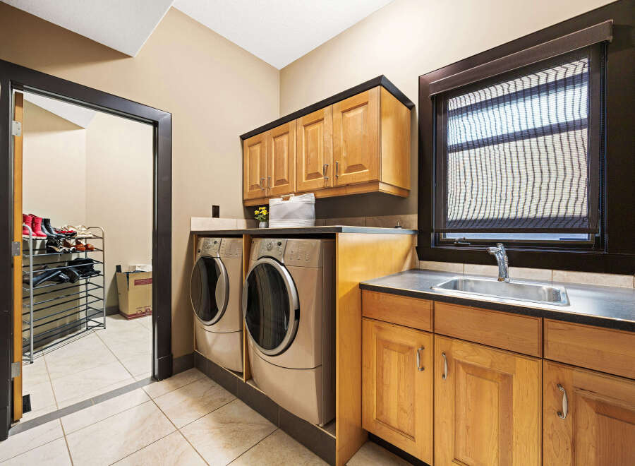 This stunning laundry room boasts modern appliances and ample storage space.