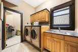 This stunning laundry room boasts modern appliances and ample storage space.
