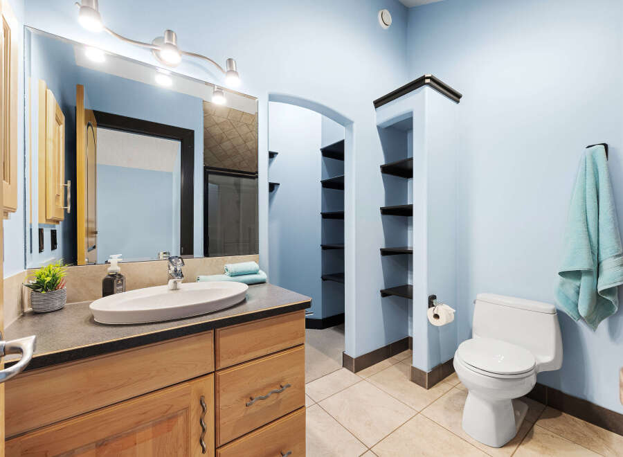 This stunning bathroom features a modern design with a light blue color scheme, creating a serene and inviting atmosphere.