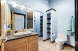 This stunning bathroom features a modern design with a light blue color scheme, creating a serene and inviting atmosphere.