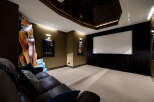 Step into luxury with this stunning home theater! Featuring a star-lit ceiling, a large screen, and comfortable seating, it's perfect for movie nights.
