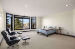 Step into luxury with this stunning bedroom featuring expansive windows that flood the space with natural light.