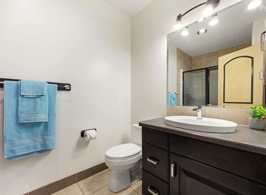 This modern bathroom features a sleek vanity with ample storage and a stylish countertop.