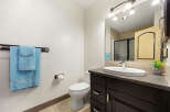 This modern bathroom features a sleek vanity with ample storage and a stylish countertop.