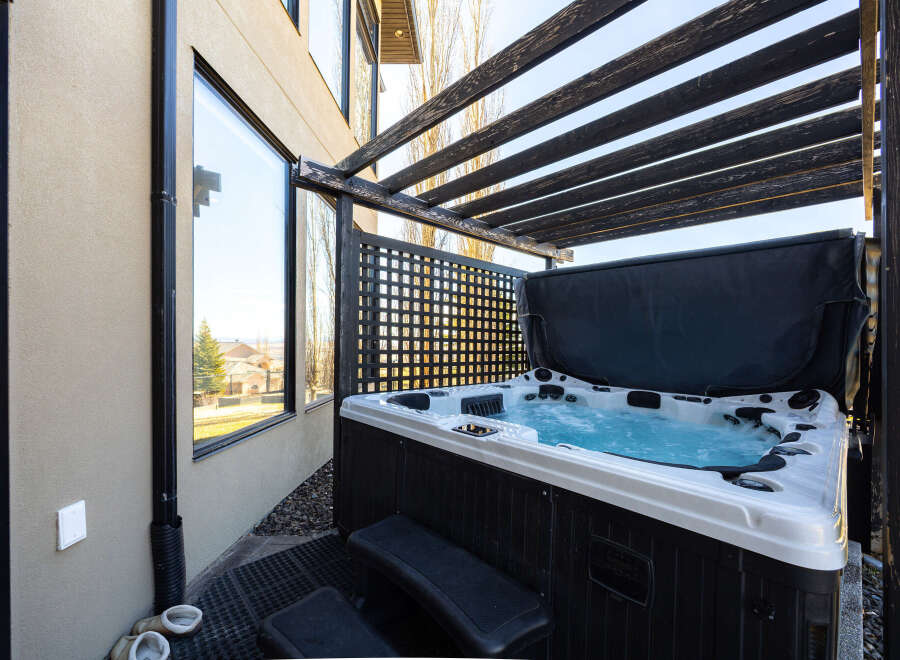 Relax and unwind in your own private oasis! This stunning property boasts a luxurious hot tub, perfect for enjoying the outdoors in any season.