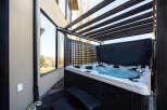 Relax and unwind in your own private oasis! This stunning property boasts a luxurious hot tub, perfect for enjoying the outdoors in any season.