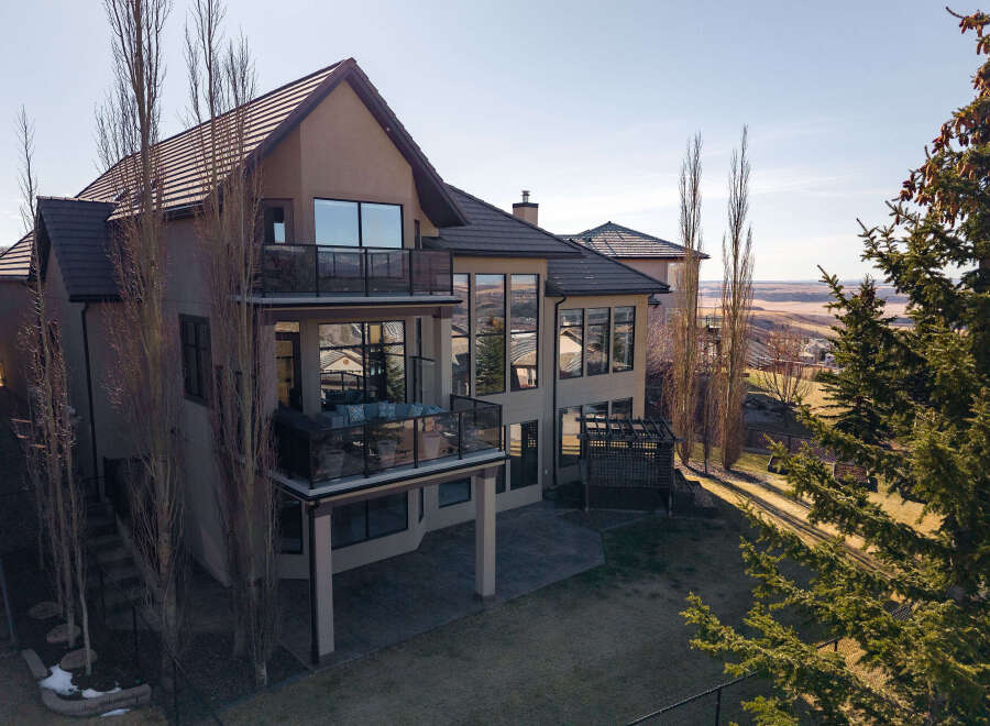 This stunning property boasts a modern design with expansive windows offering breathtaking views.