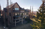 This stunning property boasts a modern design with expansive windows offering breathtaking views.