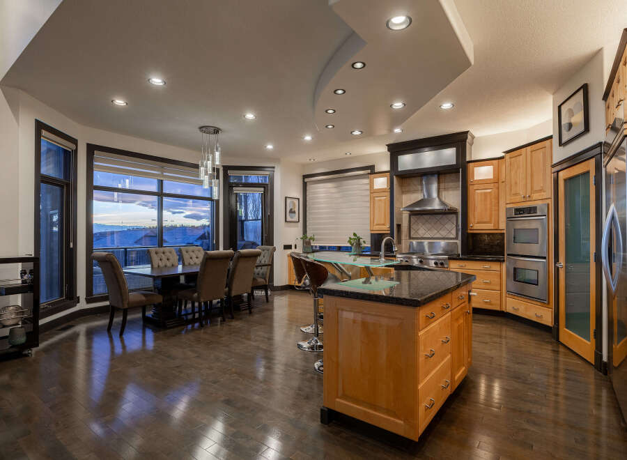 This stunning kitchen and dining area boasts a modern design with high-end finishes.